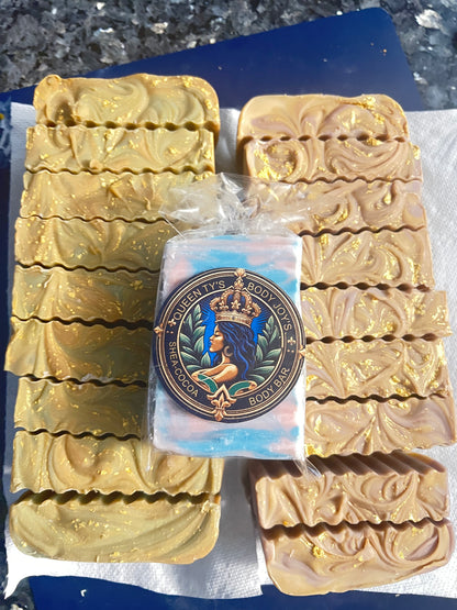 Multiple bars of soap with a branded soap bar in the center on a textured surface.